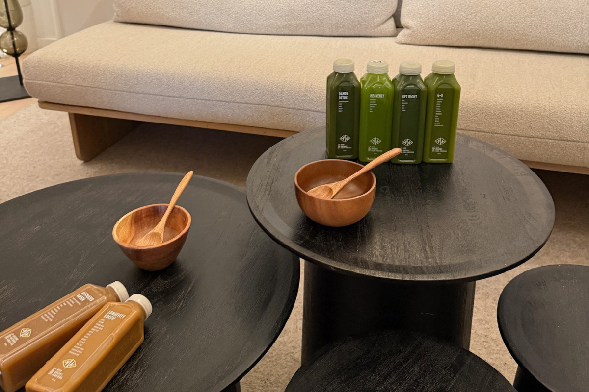 Longevity Broth, Activated Broth, Wooden Bowls & Stacked tables with green juice variety.
