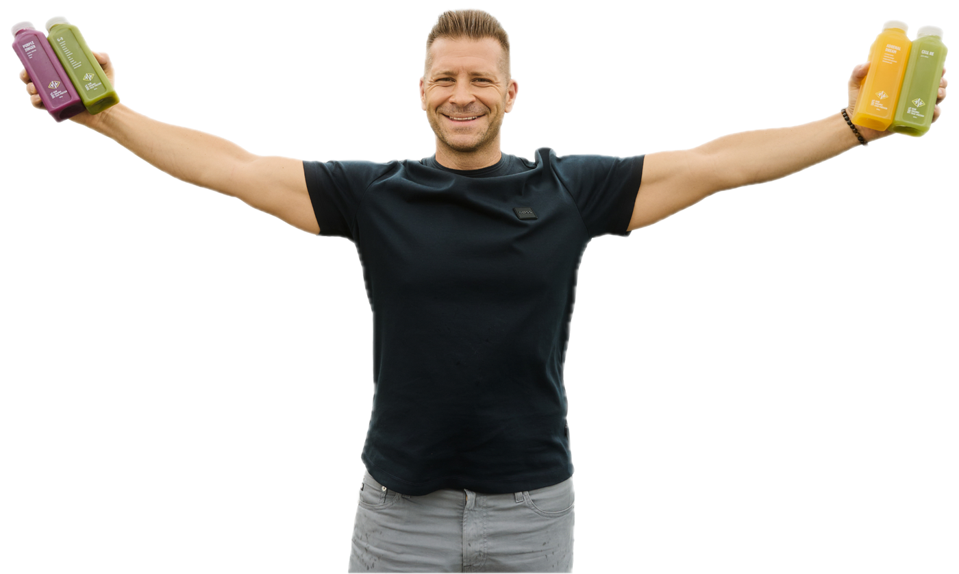Nick, The Juice Boss, arms outstretched holding HI-VIBE bottles in each hand